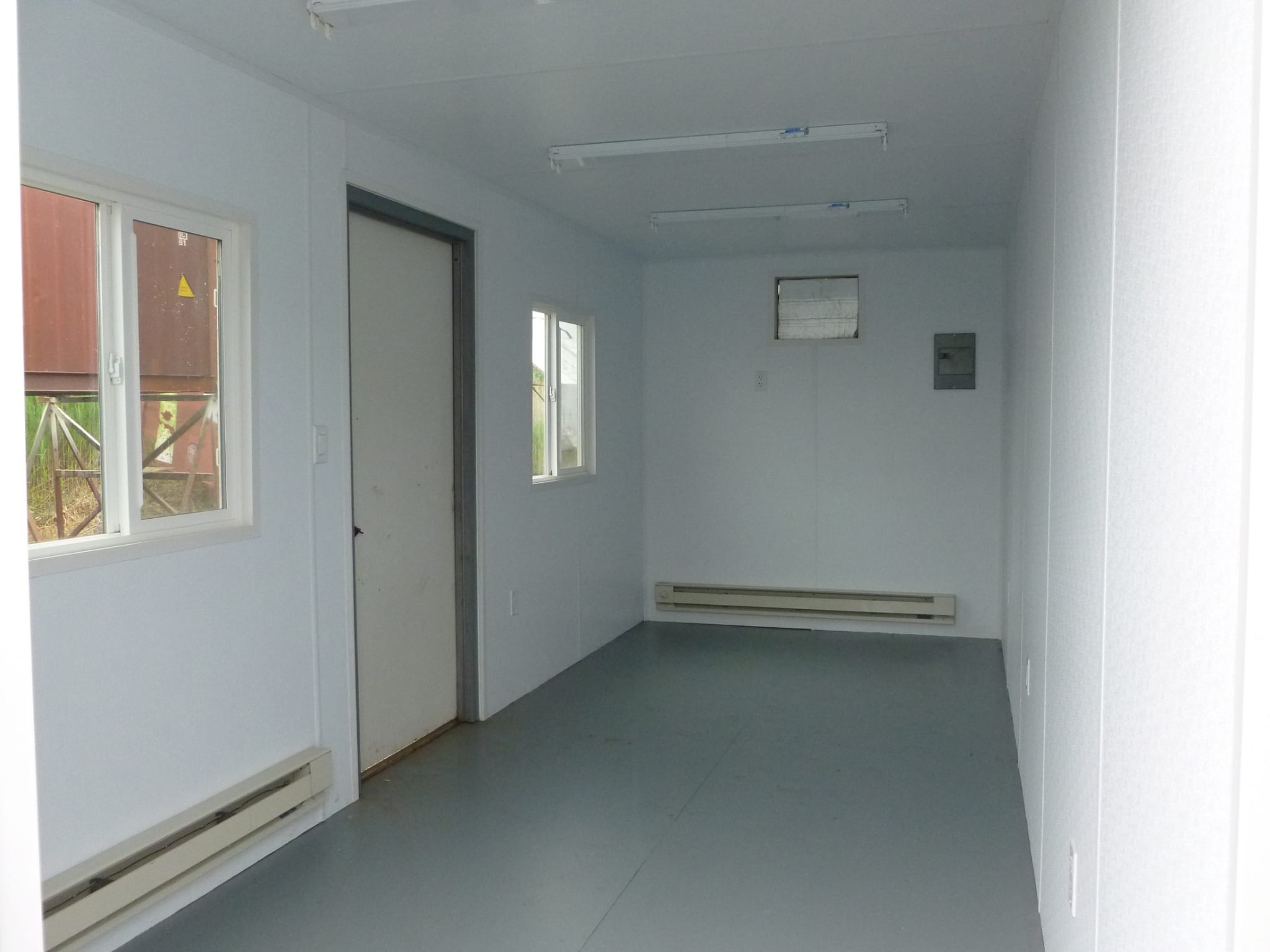 TRS Model 5 office with baseboard heating and painted plywood